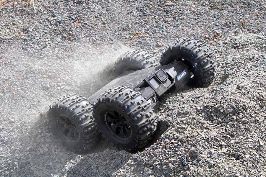 UplinkRobotics 4WD Inspection Crawler robot moving dust on gray dirt hill