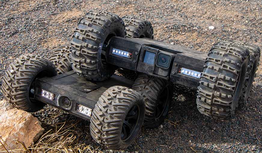 UplinkRobotics Inspection Crawler robots (mink and Pika) in Wyoming Desert with LEDs turned on.